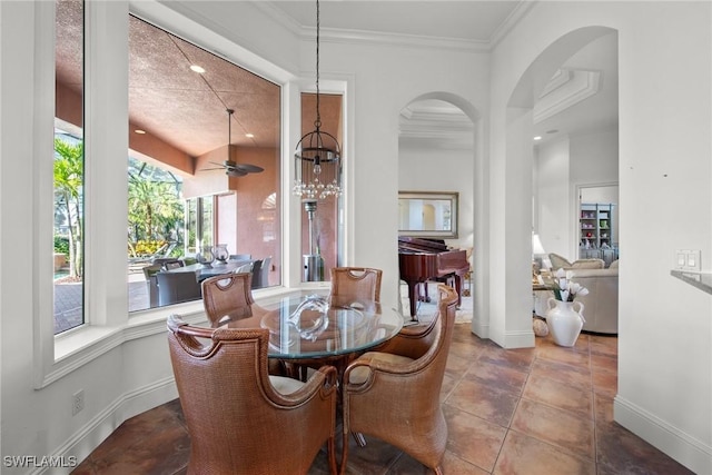 dining area with ceiling fan, a textured ceiling, and crown molding