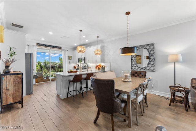 dining space with crown molding