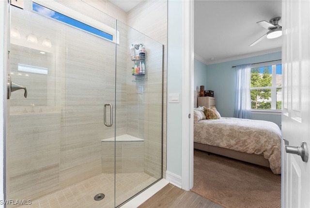 bathroom with crown molding, ceiling fan, and walk in shower