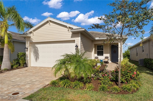 view of front of property with central AC and a garage