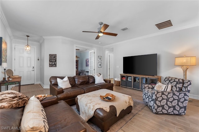 living room with crown molding, ceiling fan, and light hardwood / wood-style flooring