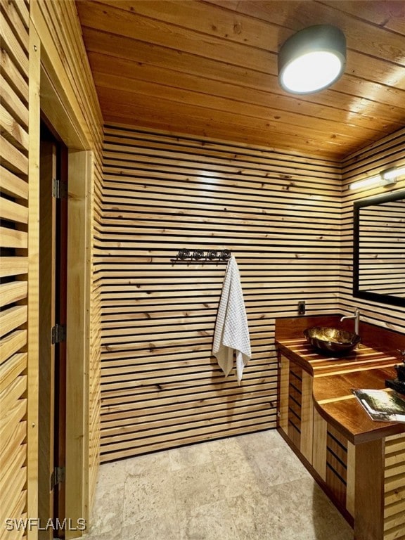 bathroom featuring wooden walls and wood ceiling