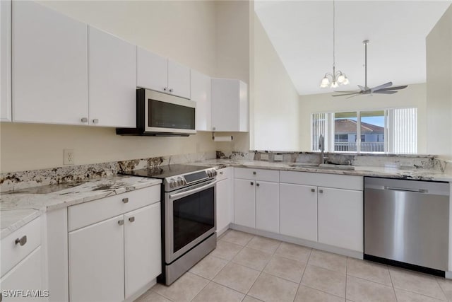 kitchen featuring appliances with stainless steel finishes, sink, white cabinets, light tile patterned floors, and ceiling fan