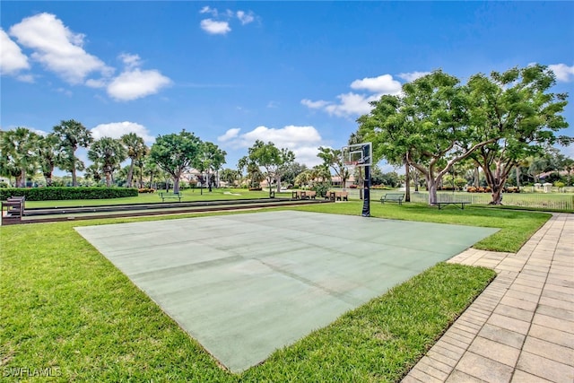 view of sport court featuring a lawn