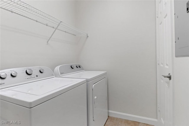 clothes washing area with separate washer and dryer and light tile patterned floors