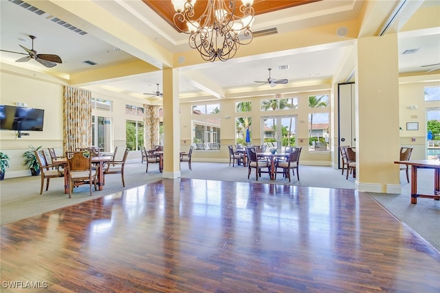 3065 Driftwood Way Unit 4206, Naples, FL 34109 - interior space with visible vents, a wealth of natural light, ceiling fan with notable chandelier, and wood finished floors