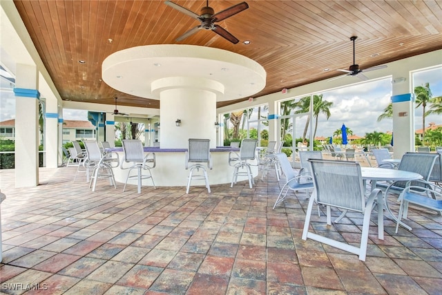 view of patio / terrace featuring ceiling fan and a bar