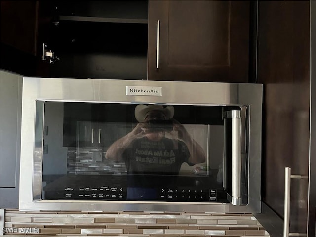 details with dark brown cabinetry and oven