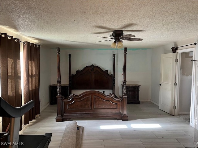 bedroom with a textured ceiling and ceiling fan