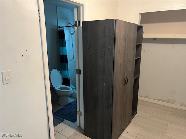 bathroom with toilet and walk in shower