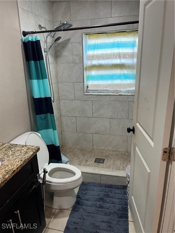 bathroom featuring tile patterned flooring, vanity, toilet, and curtained shower