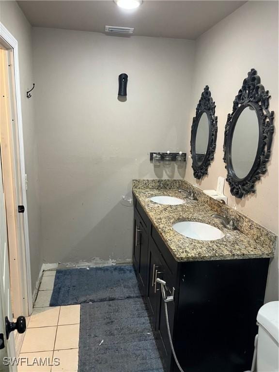 bathroom with tile patterned floors, vanity, and toilet