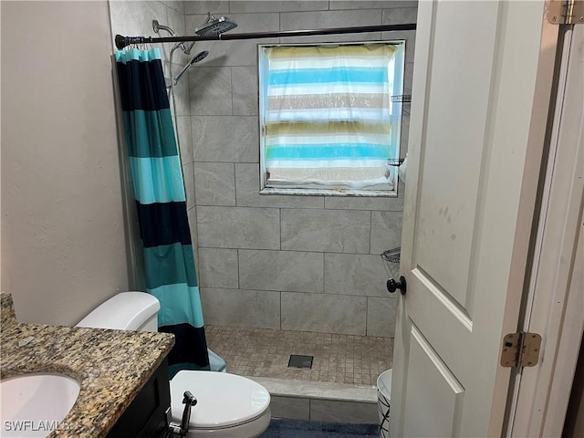 bathroom featuring vanity, toilet, and walk in shower