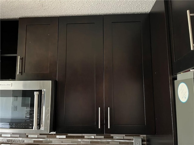 room details with dark brown cabinets and a textured ceiling