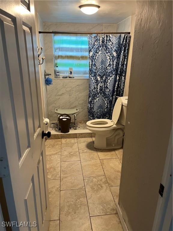 bathroom with a shower with curtain and toilet