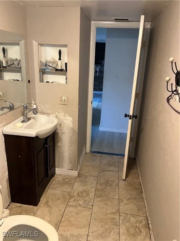 bathroom with vanity and toilet