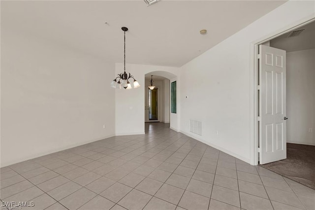 unfurnished room featuring light tile patterned floors and a chandelier