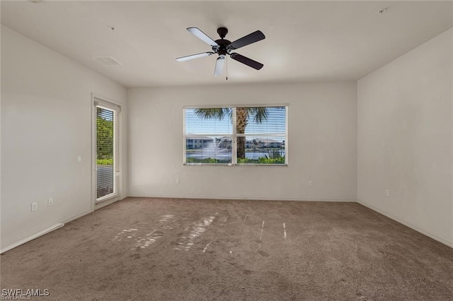 carpeted spare room featuring ceiling fan