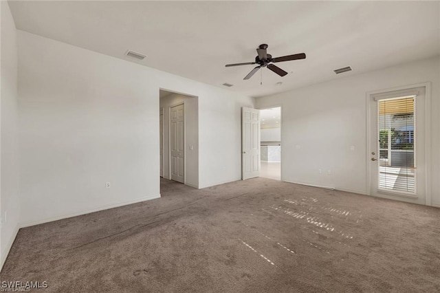 carpeted empty room featuring ceiling fan