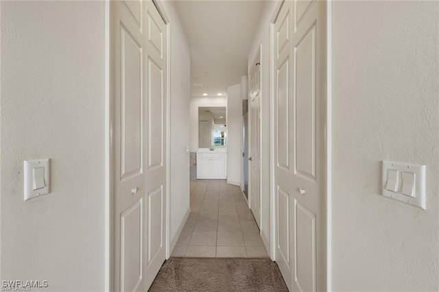 hall with light tile patterned floors