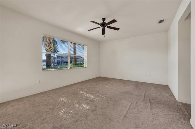 carpeted empty room featuring ceiling fan