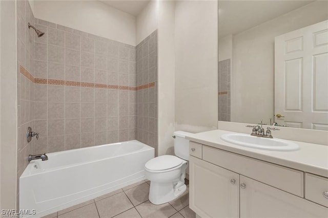 full bathroom with tile patterned floors, vanity, tiled shower / bath combo, and toilet