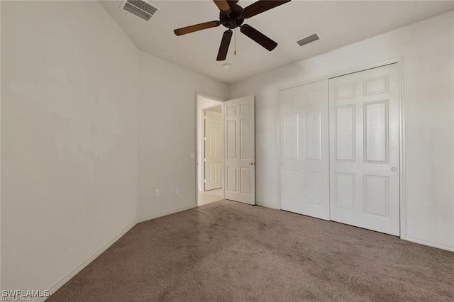 unfurnished bedroom featuring ceiling fan, light carpet, and a closet