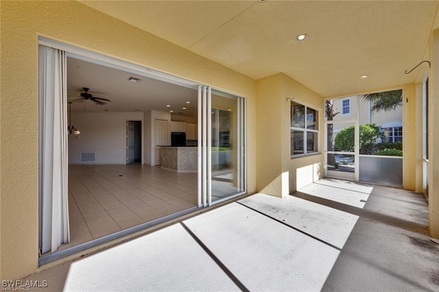 exterior space featuring ceiling fan