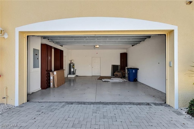 garage with electric water heater and electric panel