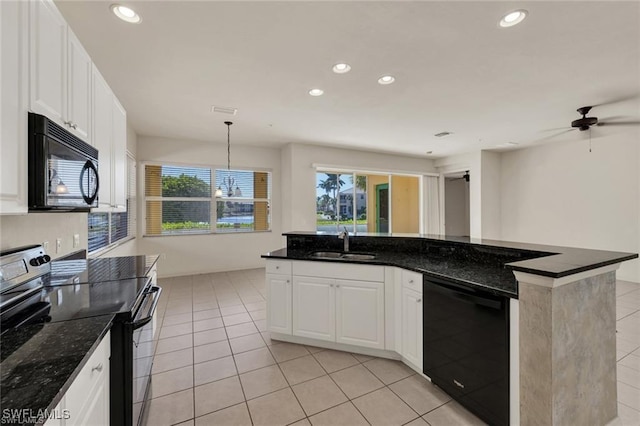 kitchen featuring dark stone counters, black appliances, white cabinets, sink, and hanging light fixtures