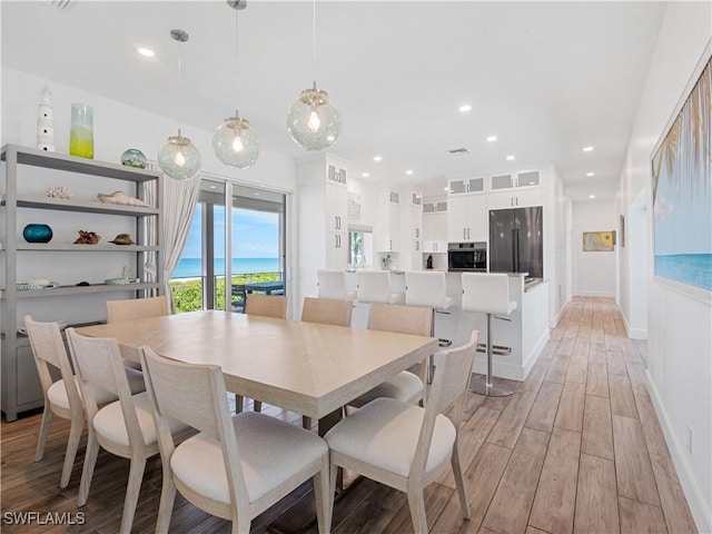 dining space with light wood-type flooring