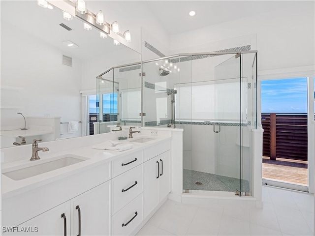 bathroom with tile patterned floors, vanity, and a shower with door