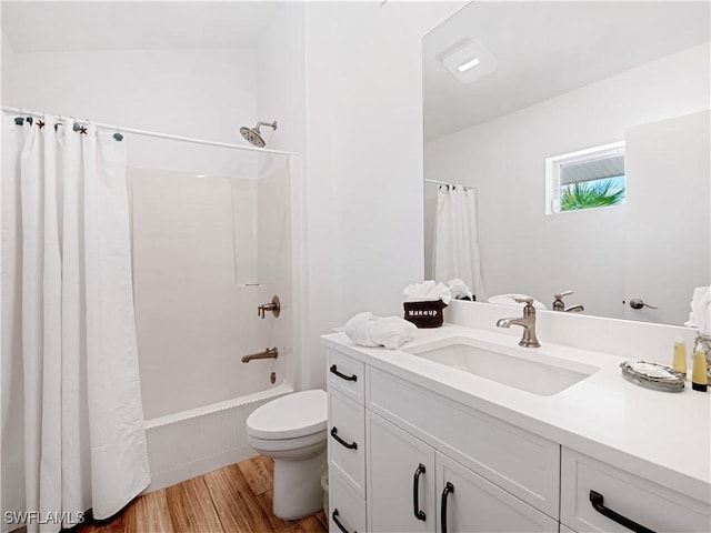 full bathroom featuring vanity, toilet, wood-type flooring, and shower / tub combo