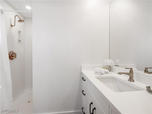 bathroom featuring vanity and a shower