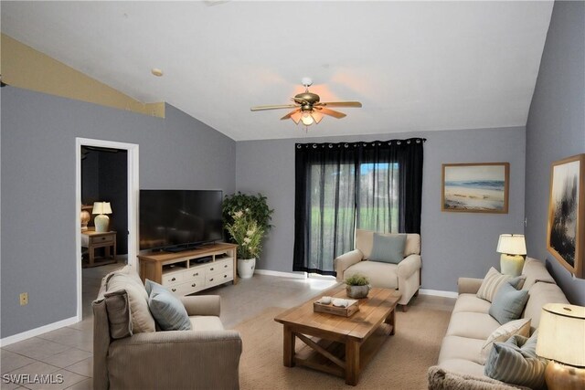 living room with ceiling fan, light tile patterned floors, and lofted ceiling