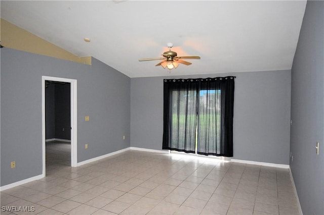 spare room with light tile patterned floors, vaulted ceiling, and ceiling fan