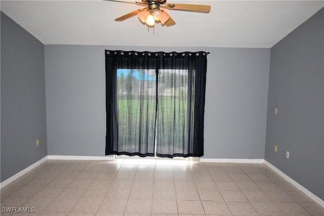 spare room featuring ceiling fan and light tile patterned floors