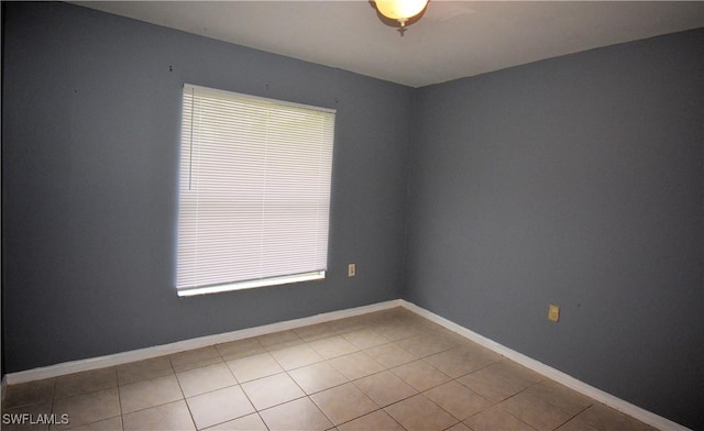 empty room with light tile patterned flooring