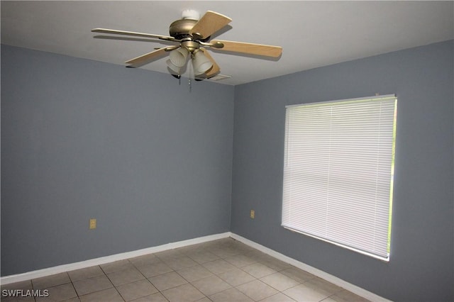 spare room with light tile patterned floors and ceiling fan