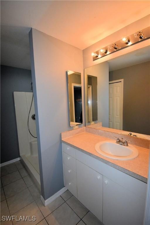 bathroom featuring a shower, vanity, and tile patterned floors