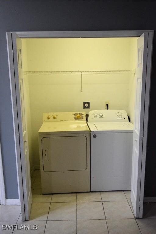 washroom featuring separate washer and dryer and light tile patterned floors