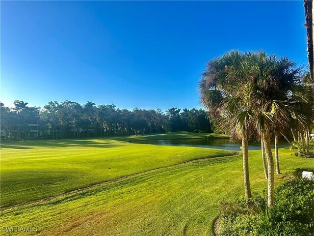 surrounding community featuring a lawn and a water view