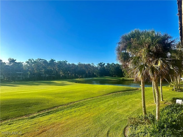 view of home's community featuring a lawn and a water view