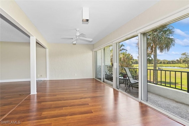 unfurnished sunroom featuring a ceiling fan