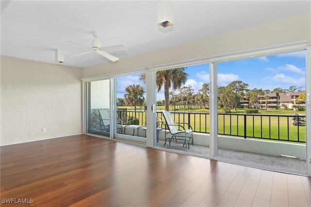 unfurnished sunroom with a ceiling fan