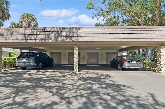 view of vehicle parking featuring a carport and a garage