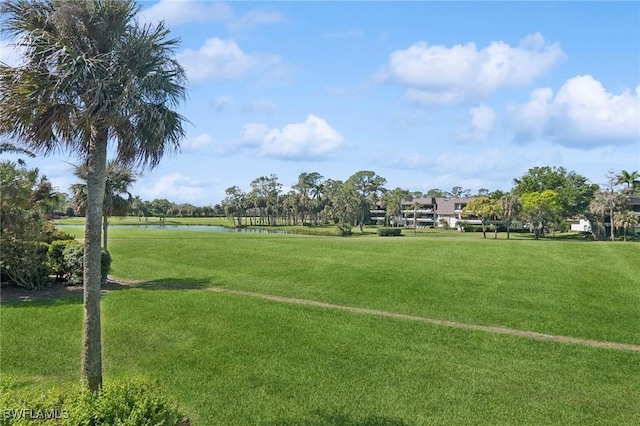 surrounding community featuring a yard and a water view