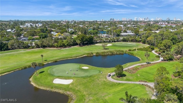 aerial view featuring a city view, view of golf course, and a water view