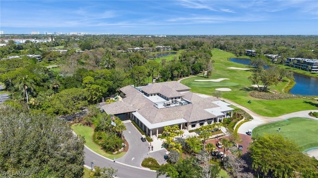 bird's eye view featuring a forest view, a water view, and golf course view