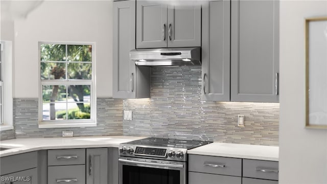 kitchen featuring tasteful backsplash, gray cabinets, and stainless steel range with electric cooktop